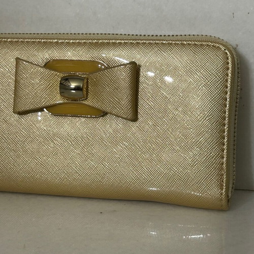 Two gold wallets, one with wrist strap