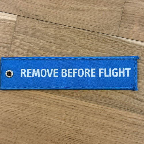 Remove Before Flight keychain in blue, like new