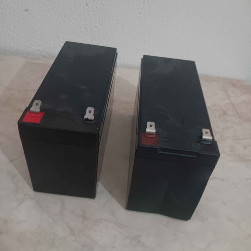 2 UPS batteries 12V 7Ah, one with edge damage