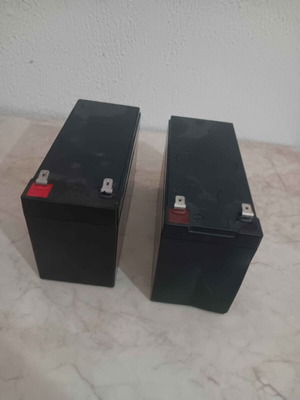 2 UPS batteries 12V 7Ah, one with edge damage
