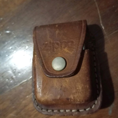 Zippo lighter with used leather case