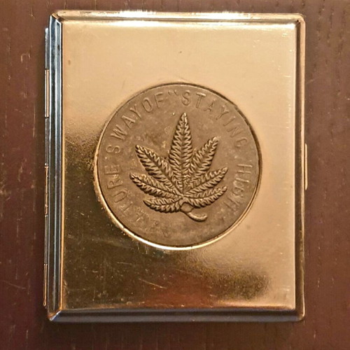 Metal cigarette case like new with embossed cannabis leaf design