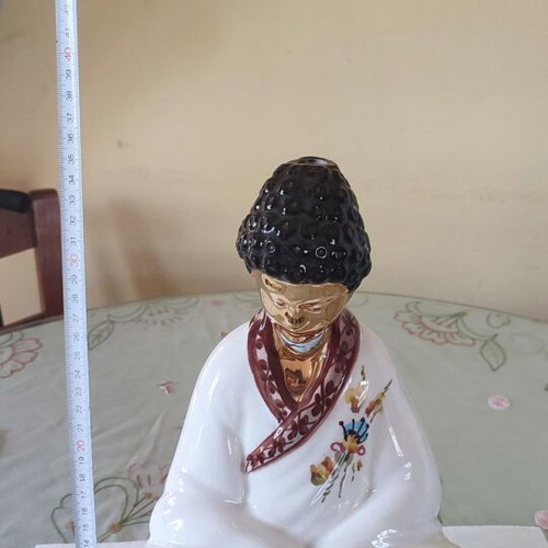 Vintage porcelain Buddha statue with gold details