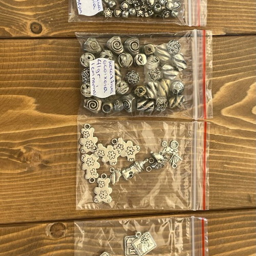Metal beads and symbols pack like new, 12 bags