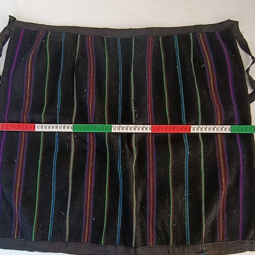 Traditional apron with colorful vertical stripes, used