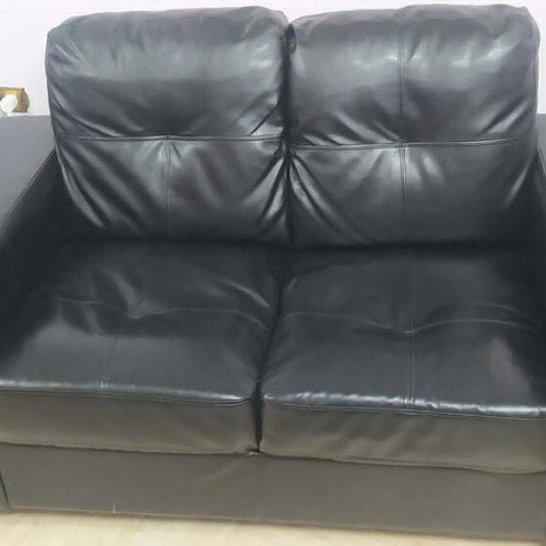 Black leatherette 2-seater sofa, 2 armchairs and 2 IKEA tables