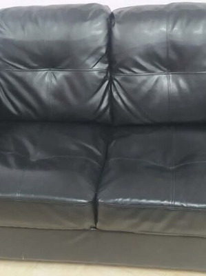 Black leather 2-seater sofa, 2 armchairs and 2 IKEA tables