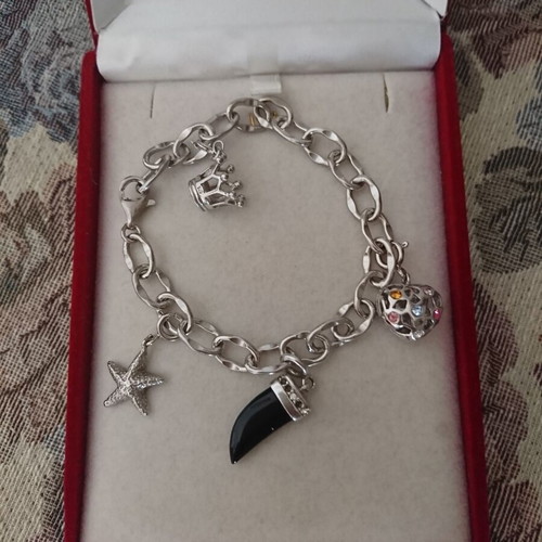 Silver bracelet with hanging charm designs like new