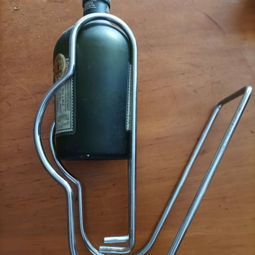 Bottle holder stainless like new with collectible rum bottle
