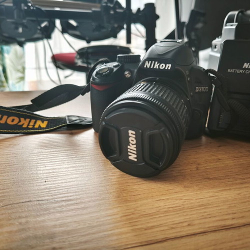 Nikon D3100 with Nikon DX AF-P Nikkor 18-55mm lens like new, includes battery and charger