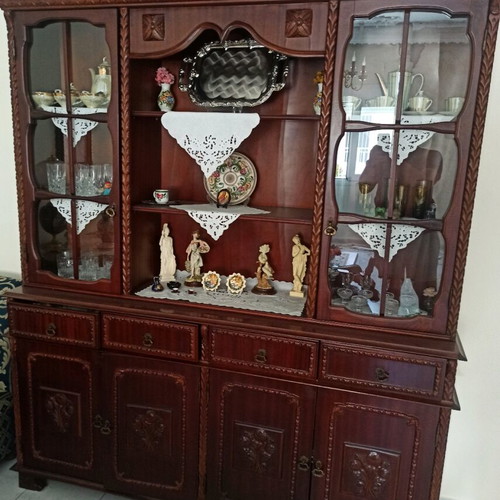 Living room cabinet used with display case and carvings
