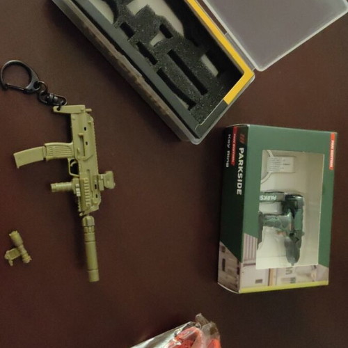 Set of various keychains with gun, drill and ribbon, unused