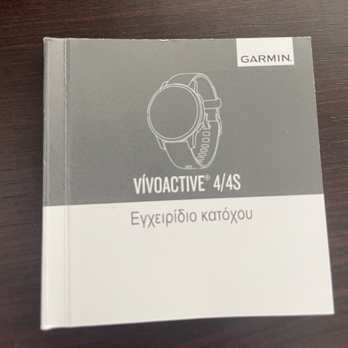 Garmin Vivoactive 4s smartwatch with charger and two straps