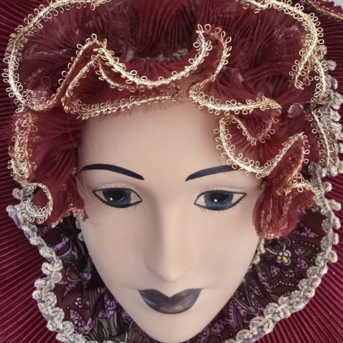 Decorative porcelain wall mask used with fabric hat in burgundy