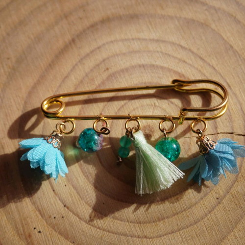 Handmade brooch with dangling elements in light blue and turquoise
