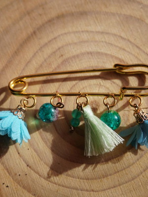 Handmade brooch with dangling elements in light blue and turquoise