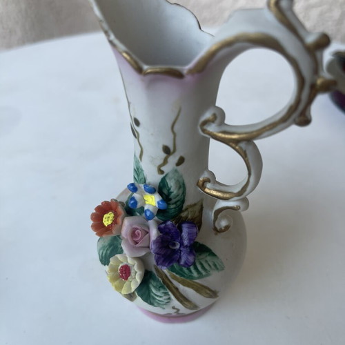 Vintage ceramic pitcher with embossed flowers used
