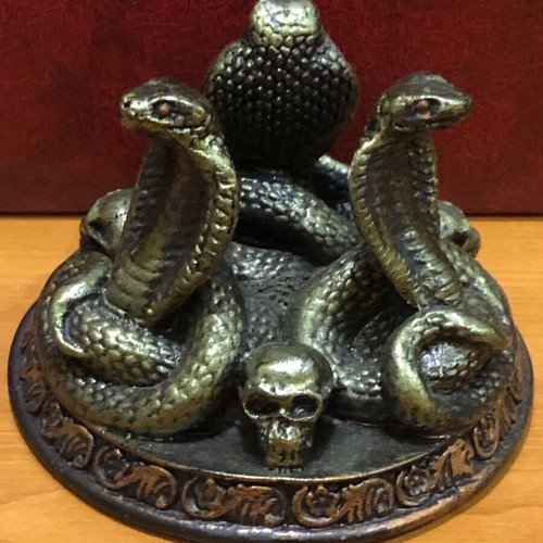 Decorative figurine with snakes and skulls