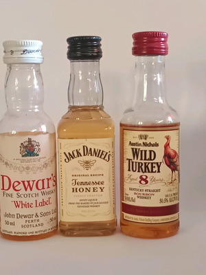 7 mini whiskey bottles, sealed plastic