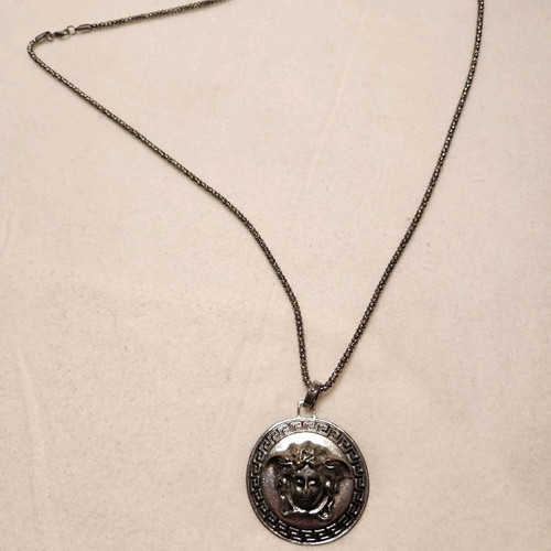 Necklace with long chain and silver face like new