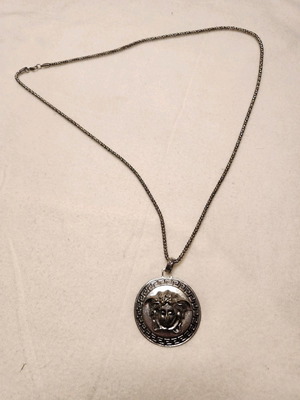 Necklace with long chain and silver face like new