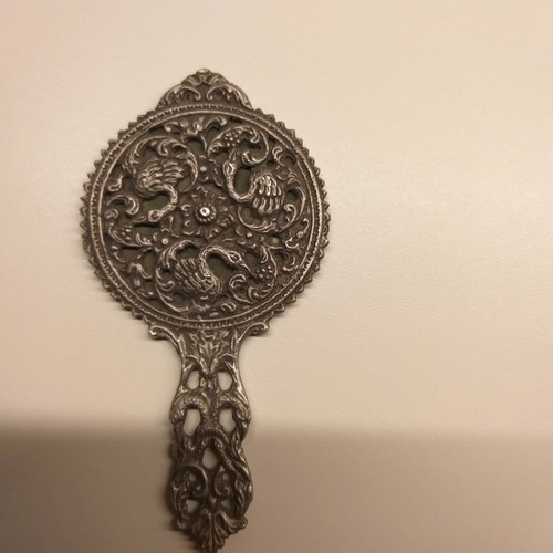 Carved old hand mirror used