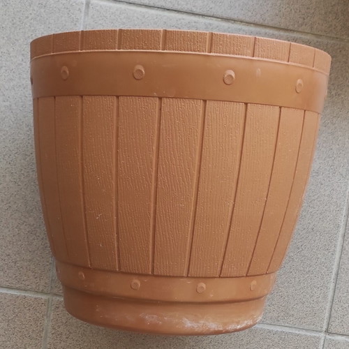 Large plastic flowerpot with saucer and metal balcony railing holder