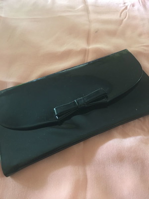 Patent leather clutch bag used, black with bow