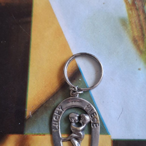 Metal keychain like new, man and woman design