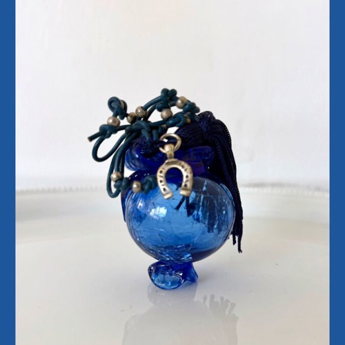 Handmade glass lucky charm in blue shades with horseshoe and silk tassel