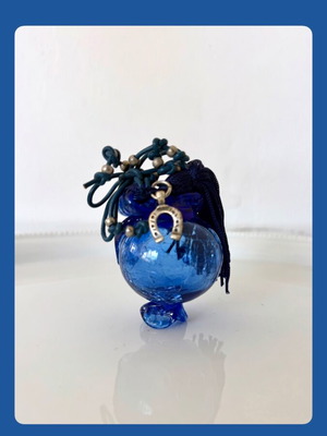 Handmade glass lucky charm in blue shades with horseshoe and silk tassel