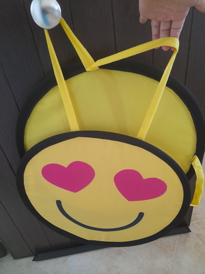 Decorative emoji wall hanging with heart eyes