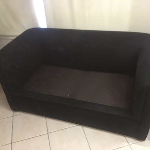 Two-seater black sofa used with wooden legs and washable fabric