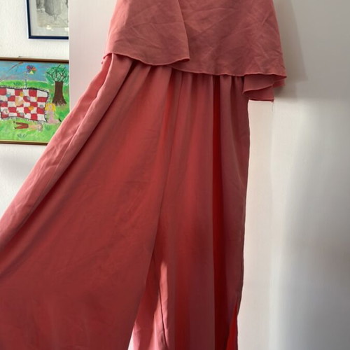 One-piece jumpsuit size S, like new, with ruffles and side openings