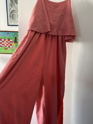 One-piece jumpsuit size S, like new, with ruffles and side openings