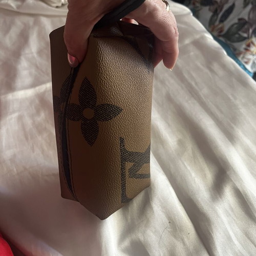 Small toiletry bag like new, brown, with zipper and wrist strap