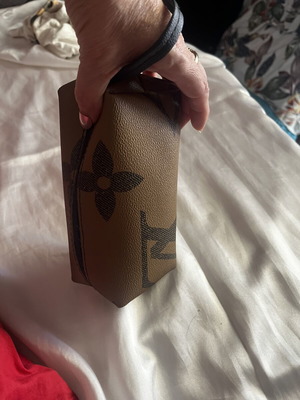 Small toiletry bag like new, brown, with zipper and wrist strap