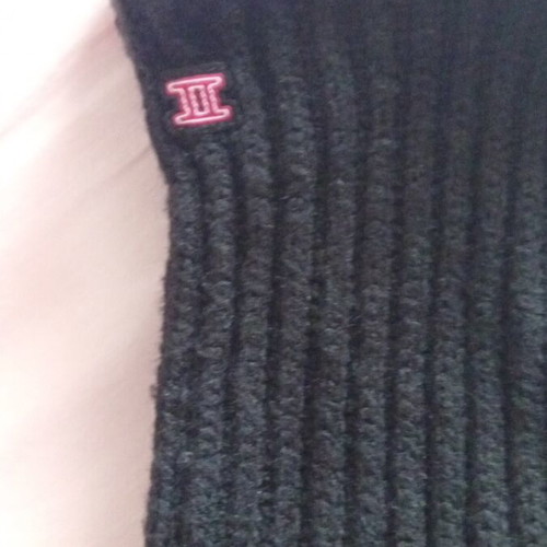 Black rib-knit gloves used with embroidered Gemini symbol