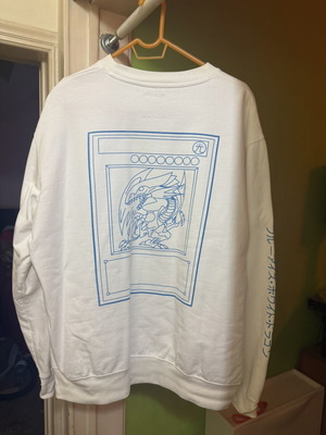 Montay Apparel White Crewneck Sweatshirt with Blue-Eyes White Dragon print from Yu-Gi-Oh!