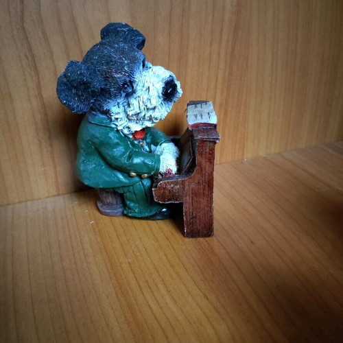 Decorative dog figure with piano like new