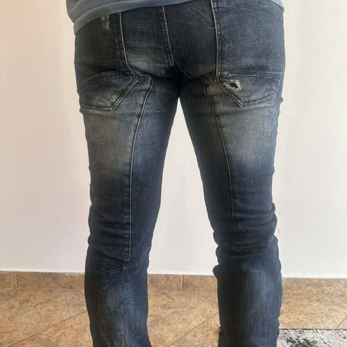 Damaged Jeans pants used with rips, blue and red