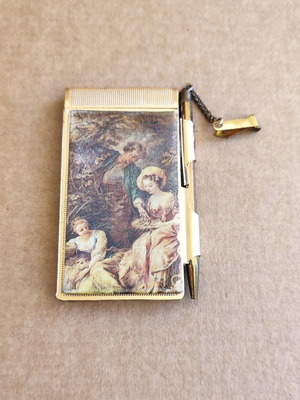 Vintage metal pocket notebook with pencil used