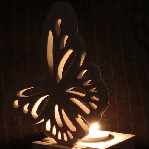 Decorative candle holder with butterfly design in white porcelain powder
