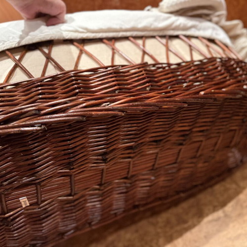 Baby bassinet with woven wicker base and hood