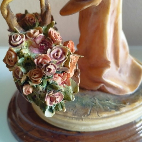 Vintage Italian decorative statue of a girl with roses, used