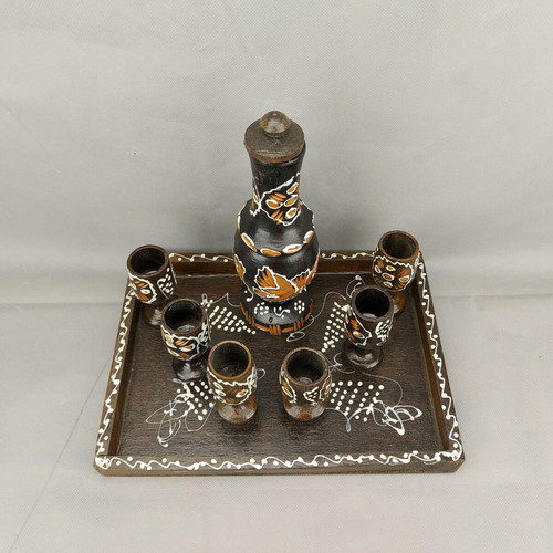 Vintage carved painted wooden bottle with 6 glasses on wooden tray used
