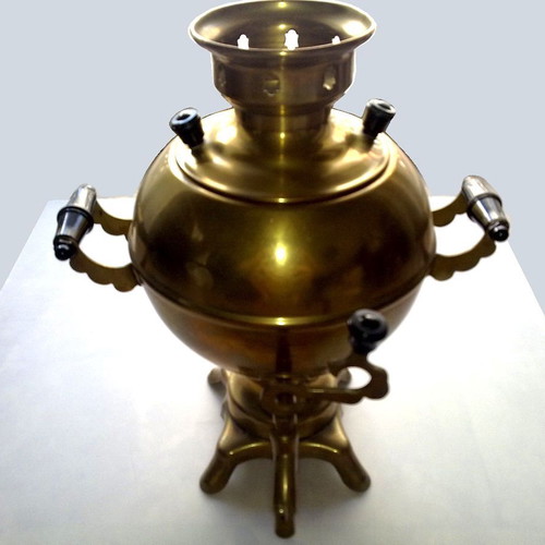 Bronze teapot with spout and heating element used