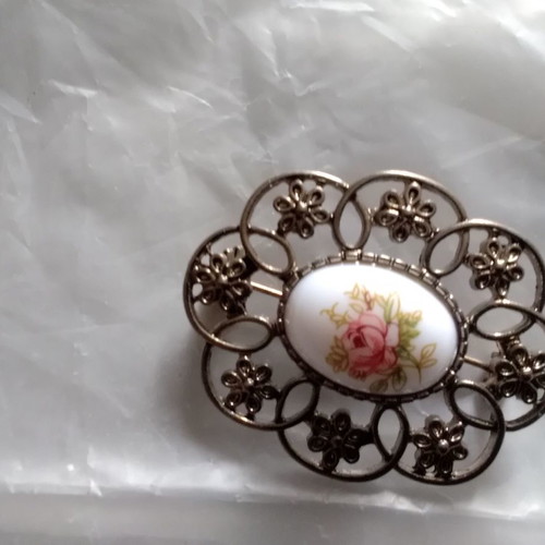 Metal brooch with porcelain detail used