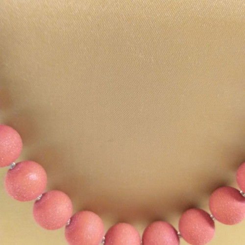 Orange-red necklace with textured stones used