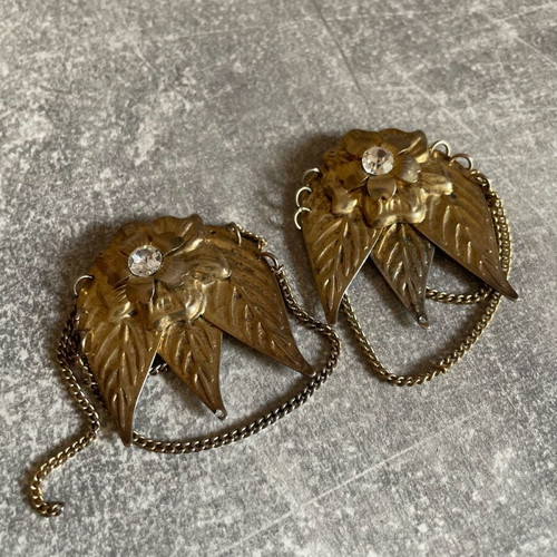 Gold-colored earrings used with flowers